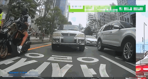 지난 8월27일 오후 4시쯤 부산 부산진구 한 도로에서 번호판 없는 오토바이를 탄 운전자가 단속을 나온 교통경찰관을 매달고 달리는 일이 벌어졌다./사진=한문철TV 