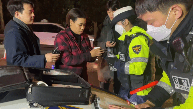 9일 오후 10시쯤 서울 마포구의 한 도로에서 가수 이미쉘씨가 음주 측정에 앞서 경찰이 건네 준 물을 마시려 하고 있다/ 사진= 이지현 기자