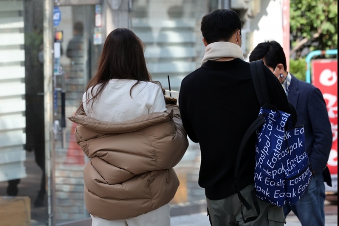 오는 28일엔 낮과 밤 기온차가 15도 이상으로 크다. 사진은 19일 서울 중구 명동거리에서 한 시민이 외투를 반쯤 걸친 모습. /사진=뉴스1