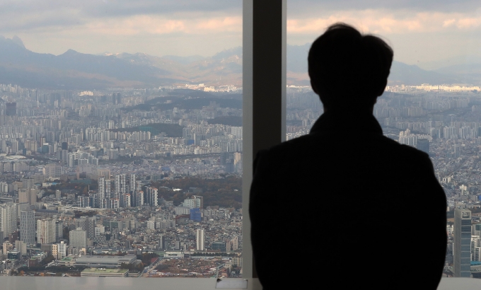 한국은행이 25일 기준금리를 연 0.75%에서 연 1%로 인상하면서 은행권 대출 금리는 앞으로 더 오를 전망이다. 사진은 서울 송파구 롯데월드 서울스카이 전망대를 찾은 관람객이 아파트단지가 밀집한 서울시내를 바라보는 모습./사진=뉴스1