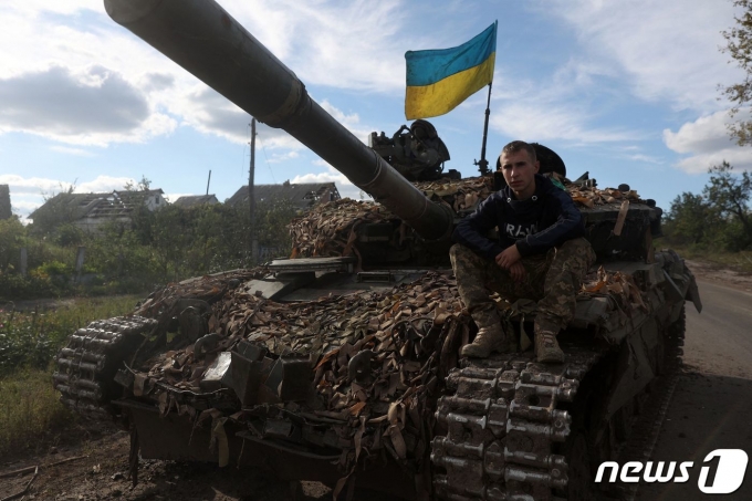 22일 (현지시간) 최근 러시아 군의 공격을 격퇴한 우크라이나 도네츠크 돌리나 도로에서 병사가 탱크 위에 앉아 있다. ⓒ AFP=뉴스1 ⓒ News1 우동명 기자